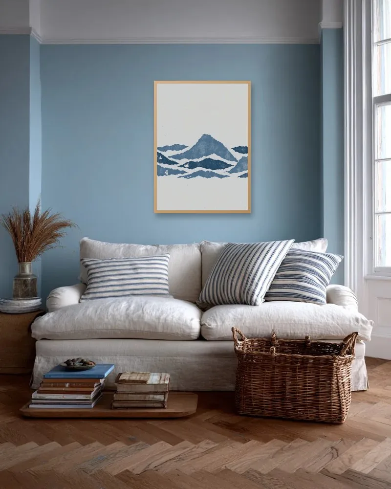 A piece hung to scale above a sofa on a pale blue wall