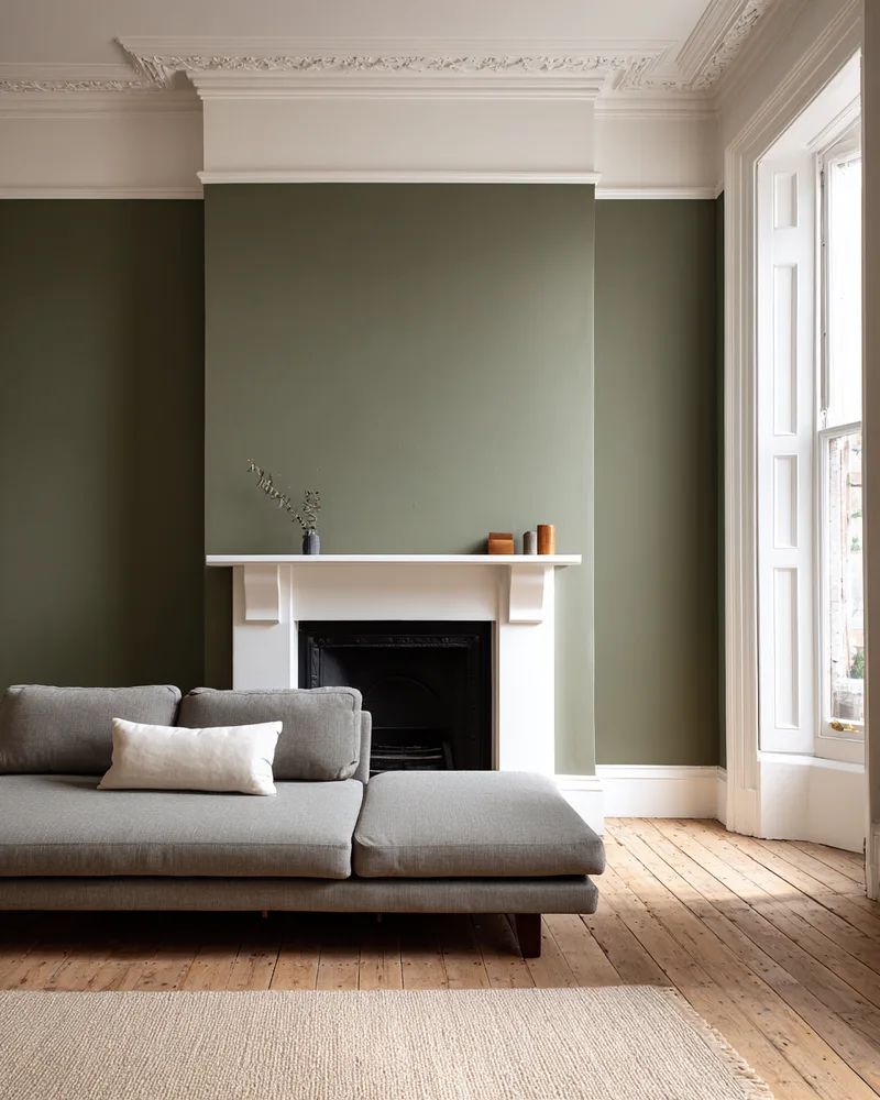 Victorian living room with olive walls and fireplace